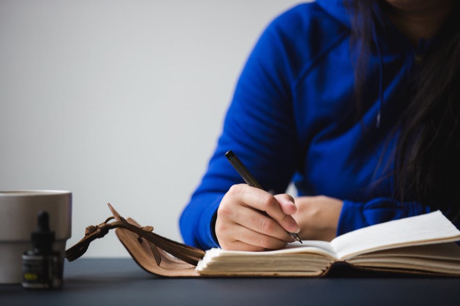 Writing reflections and goals in a journal